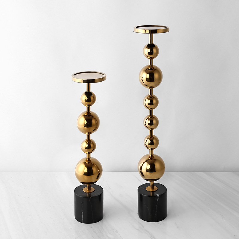 Metal candle holder with marble base adds a timeless elegance to any space blending durability with artistic craftsmanship